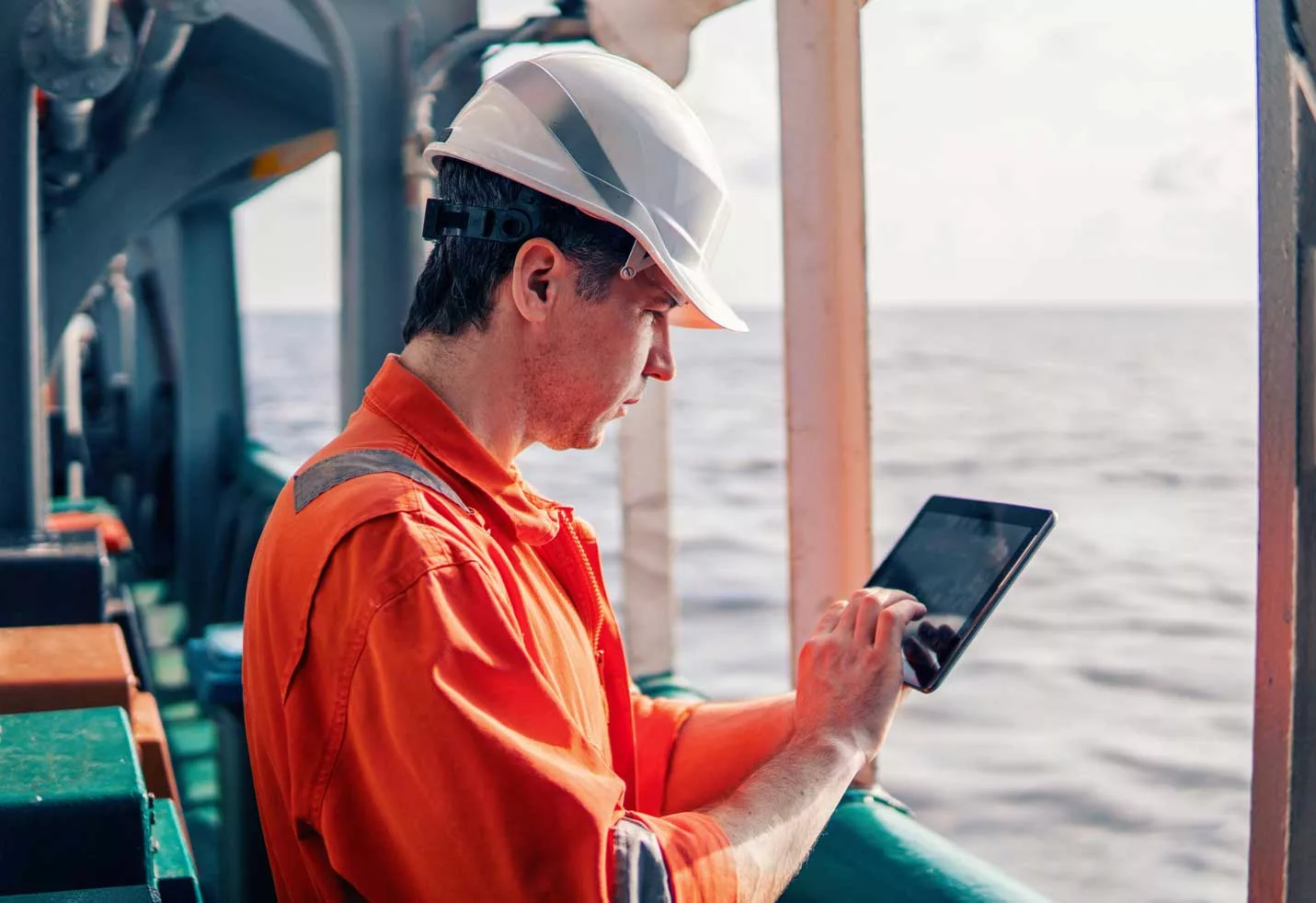 AdobeStock_251047785 man looking at tablet on ship